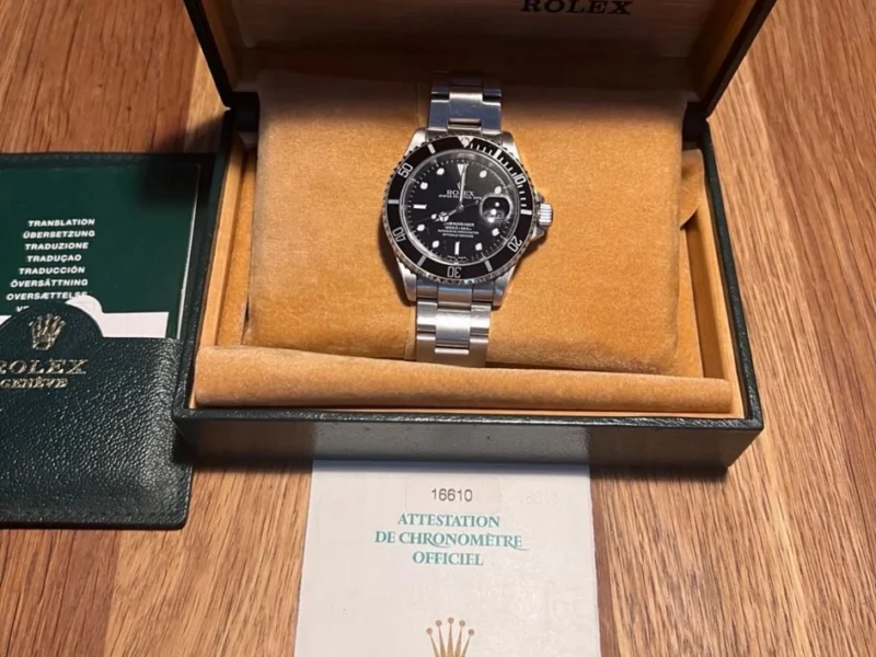 Armbanduhr in geöffneter Herstellerbox mit Papieren