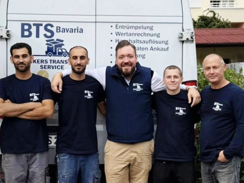 Fünf Mitarbeiter von BTS Bavaria in Firmenkleidung vor dem beschrifteten Transporter